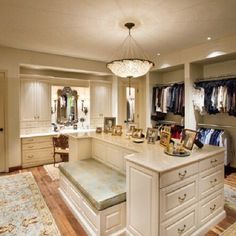 a large walk in closet with an island