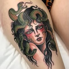 a woman's thigh with a snake on her head and two snakes around her body