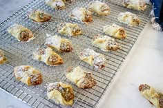 pastries on a cooling rack with powdered sugar