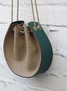 a handbag hanging on a white brick wall