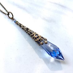 This beautiful necklace is made with a genuine marked Swarovski Icicle light sapphire crystal.  The crystal is 40 mm long and with the brass filigree it is 50 mm in length.  You can choose what length you want the brass chain for this beautiful crystal to dangle from.  The necklace comes in a black jewelry box, so its ready to wrap  if this is to be a gift.  The necklace will be sent USPS first class mail. Black Jewelry Box, Brass Filigree, Light Sapphire, Casual Cosplay, Necklace Crystal, Black Jewelry, Sapphire Necklace, Beautiful Necklace, Brass Chain