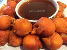 some fried food is on a plate with dipping sauce