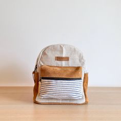 Fashionable and sporty, the mini backpack hails from the WoVen collection in Nepal. Made from hand-loomed cotton material, the bag features an earthy tone of Allo and caramel suede leather trim. This cute, practical mini backpack is ideal for everyday essentials! Everyday Beige Backpack With Leather Trim, Beige Backpack With Leather Trim For Everyday Use, Everyday Brown Cotton Backpack, Eco-friendly Brown Backpack For Everyday, Eco-friendly Brown Everyday Backpack, Eco-friendly Everyday Brown Backpack, Everyday Eco-friendly Brown Backpack, The Bag, Buy Handmade