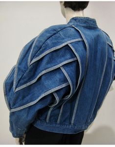 a mannequin wearing a blue jean jacket with white stripes on it's sleeves