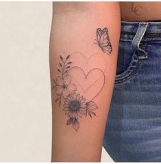 a woman's arm with a butterfly and flowers tattoo on the left side of her arm