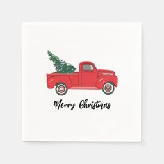 a red truck with a christmas tree in the back and merry christmas written on it