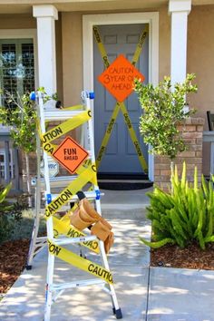 a ladder with caution signs on it in front of a house