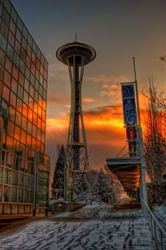 the space needle at sunset in seattle, usa with snow on the ground and trees