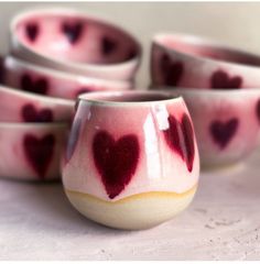 several small bowls with hearts painted on them