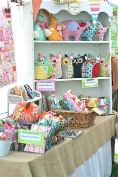 a table with many items on it and people looking at them in the back ground