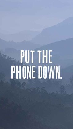 the words put the phone down are shown in white on a blue background with mountains