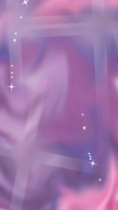 a blurry photo with stars in the sky and pink, purple and blue colors