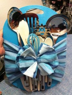 a blue holder with utensils and spoons in it