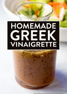 homemade greek vinaigrette in a small glass jar with a black sign that says homemade greek vinaigrette