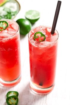 two glasses filled with watermelon and garnish next to sliced jalapenos