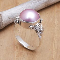 Crowned by an orb of cultured pearl with soft, dyed pink hues, this Balinese cocktail ring brings a sweet beauty wherever it goes. Designed by Buana, the band is handcrafted of sterling silver with jepun, or frangipani flowers that flank the pearl. Mabe Pearl Jewelry, Pearl Cocktail Ring, Goddess Jewelry, Mabe Pearl, Pink Pearl, Balinese, Pearl Color, Favorite Rings, Jewelry Packaging