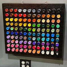 an art piece with many different colored buttons on the front and back of it,