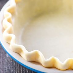 an uncooked pie crust sitting on top of a white plate