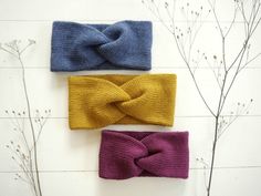 three knitted headbands on top of each other, one with a knot