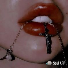 a close up of a person with a cross on it's nose and chain around their neck