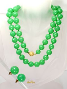 "This is an original Art Deco 1930s vintage green faux Jade Celuloid / Early Plastic  jewelry set: beaded necklace and clip-on earrings. The necklace measures almost 29\" long, it weighs 1.4 oz and the beads are 3/8\" in diameter.  The earrings are 3/4 in diameter and the weight of one earring is 0.1 oz.  It is a vintage item in excellent condition. We combine shipping,  Thank You for visiting our Etsy https://www.etsy.com/shop/VictoryIssweet store!" Formal Green Single Strand Beaded Necklace, Formal Green Beaded Necklace, Green Single Strand Jewelry For Party, Single Strand Green Jewelry For Party, Vintage Single Strand Jade Jewelry, Vintage Jade Jewelry With Round Beads, Mid-century Green Formal Jewelry, Vintage Jade Beaded Necklaces, Vintage Green Jade Necklaces