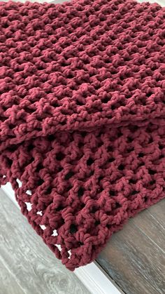 a crocheted blanket on top of a wooden table