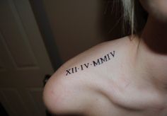 a woman's shoulder with roman numerals tattooed on her left arm and chest