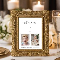 a gold frame with an image of a baby on it and two candles in the background