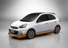 an orange and white small car on a gray background