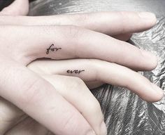 two fingers with the words for ever tattooed on them