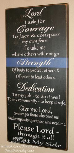 a sign that is on the wall in front of a door saying, lord i ask for courage to face and conquer