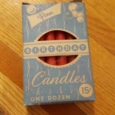 a box of candles sitting on top of a wooden table