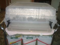 three plastic storage containers stacked on top of each other in a kitchen with tile flooring