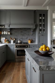 a bowl of lemons on top of a kitchen counter