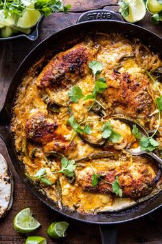 chicken enchilada in a skillet with limes and cilantro