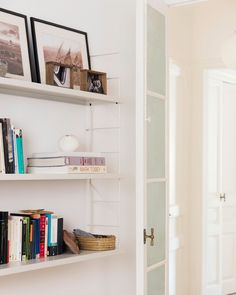 the bookshelves in this room are full of books and magazines, along with pictures on them