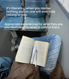 an open book sitting on top of a chair next to a pair of jeans and a backpack