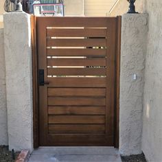 a wooden door is open in front of a house