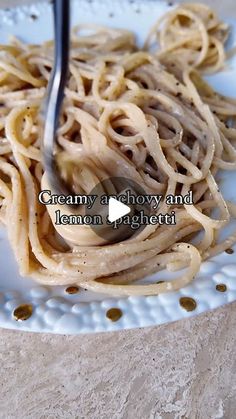 a white plate topped with pasta and sauce