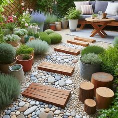 a garden with rocks and wooden benches surrounded by plants