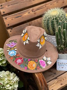 This Mexican Suede Hat is perfect to add that special touch to any outfit. This Mexican Hat is completely hand painted and one of a kind! This structured suede hat has a high crown and a teardrop top. The wide brim is accented by a band and colorful painted flowers. The hat is made in Mexico by artisanal hands made with love for you to look gorgeous and fashionable. Adjustable Bohemian Hand Painted Hat, Hand Painted Short Brim Hat For Western-themed Events, Hand Painted Brown Wide Brim Hat, Hat Design Ideas, Casual Hand Painted Hat, Mexican Hand Painted Hats, Embroidery Hat, Traditional Mexican Dress, Mexican Hat