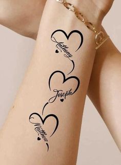 two hearts with name tattoos on the arm