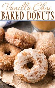 vanilla glazed baked donuts on a piece of parchment paper with a cup of coffee in the background