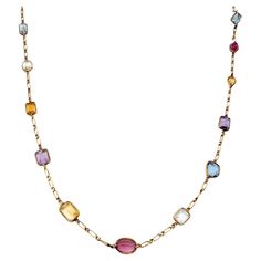 Long, luxurious multi-gemstone station necklace bursting with color. This amazing piece absolutely lights up the neck! Featuring 21 assorted bezel set gemstones on an elongated link chain, the colorful stones pop against the warm yellow gold setting. Shades of pink, blue, purple, yellow, orange and green radiate throughout the piece, each a different shape and hue. This necklace can be dressed up or down and adds the perfect pop of color to your look. The long piece can also be wrapped around th Asymmetrical Jewelry, Purple Yellow Orange, Multi Gemstone Necklace, Colorful Stones, Bezel Necklace, Color Jewelry, Warm Yellow, Gold Long Necklace, Gem Necklace