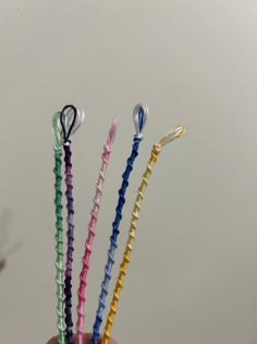 three different colored toothbrushes in a person's hand on a white background