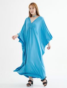 "🚚..ALL ORDERS ARE SHIPPED VIA DHL EXPRESS MAIL This soft light blue caftan dress is a great timeless wardrobe essential that you should not miss. Great for all shapes and sizes. * Pullover style * Deep v neck * Ruched detail at front with weaving rope strips * Batwing sleeves * Relaxed fit * For a slouchy silhouette * Unlined Measurements approximately: Sleeve Length (from side of neckline): 25\" (63.5 cm) Sleeve cuff: 18\" (46 cm)-round Bust: 66\" (168 cm)-all around. Hips: 60\" (152 cm)-all Light Blue V-neck Maxi Dress For Beach, Light Blue Maxi Dress For Beach Cover-up, Long Maxi Dress For Vacation, Blue Maxi Dress For Summer Loungewear, Blue Bohemian Tunic For Daywear, Bohemian Flowy Kaftan For Daywear, Flowy Bohemian Kaftan For Daywear, Solid Bohemian Maxi Dress, Long Bohemian Kaftan For Daywear