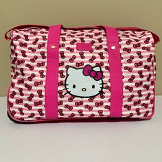 Bioworld Sanrio Hello Kitty Wheeled Travel Duffle Carry-On Luggage Bag -Approximate Measurements/Dimensions: 20”W X 12”H X 11”D -Pink/Multi Exterior -Black Interior -Hello Kitty Design & All-Over Bow Print -One Main Compartment -One Interior Zipper Compartment -Two Interior Slip Pockets -Gold Hardware -Man Made Material -New With Tags Carryon Luggage, Rolling Duffle Bag, Pink Duffle Bag, Hello Kitty Bag, Uniqlo Bags, Weekend Travel Bags, Hello Kitty Cartoon, Bow Print, Luggage Suitcase