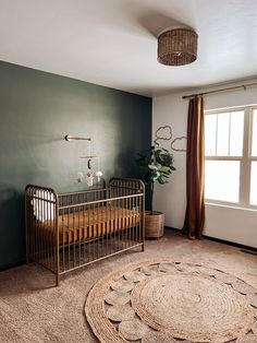 a baby crib in the corner of a room with a rug on the floor