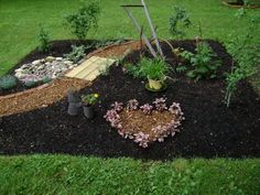 a garden with various plants and flowers in the center, including an arch over which is shaped like a heart