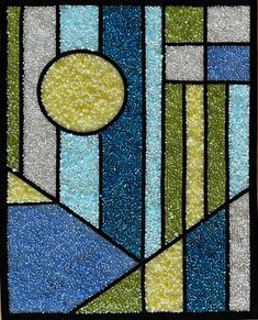 a stained glass window with blue, green and yellow colors